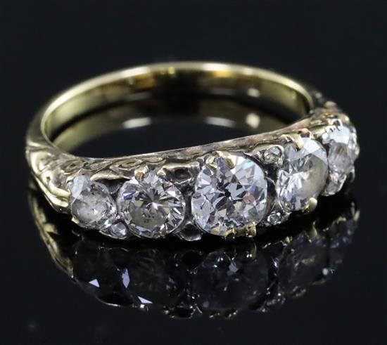 A late Victorian gold and graduated five stone diamond half hoop ring, size M.